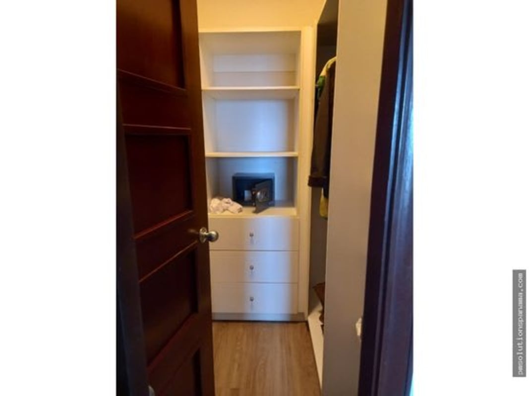 Kitchen space with wood cabinetry, granite-style counters, appliances in PH Grandbay Panama City