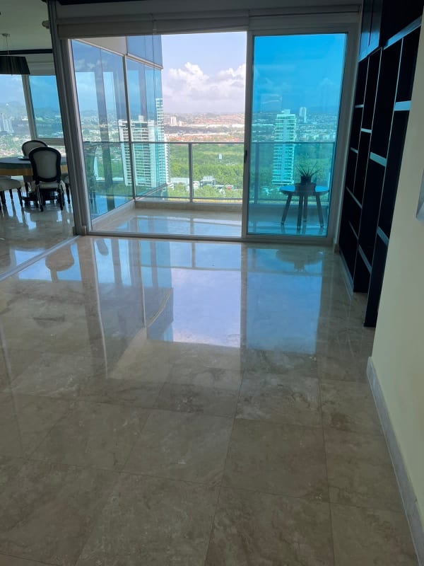 Bright modern living room with marble floors and floor-to-ceiling windows in PH Titanium Costa del Este Panama