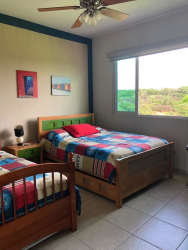 Bedroom with king-size bed, ocean vista and contemporary décor in Bijao Beach Club Panama