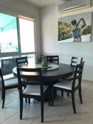 Modern dining room with large window and ocean views at Bijao Beach Club Residence Panama