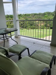Covered terrace balcony with lounge furniture and stunning ocean scenery at Bijao Beach Club Condo Panama