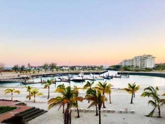 Furnished bedroom with sliding doors to patio, pool and marina view Marina Village Buenaventura