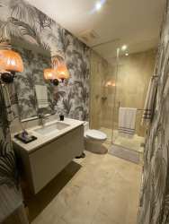 Scenic marina with boats, Pacific beach and palm trees at Marina Village Buenaventura Panama