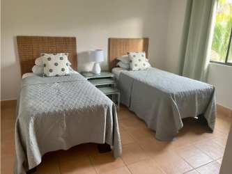 Coastal bedroom with twin beds and large window at Bristol Residences Panama