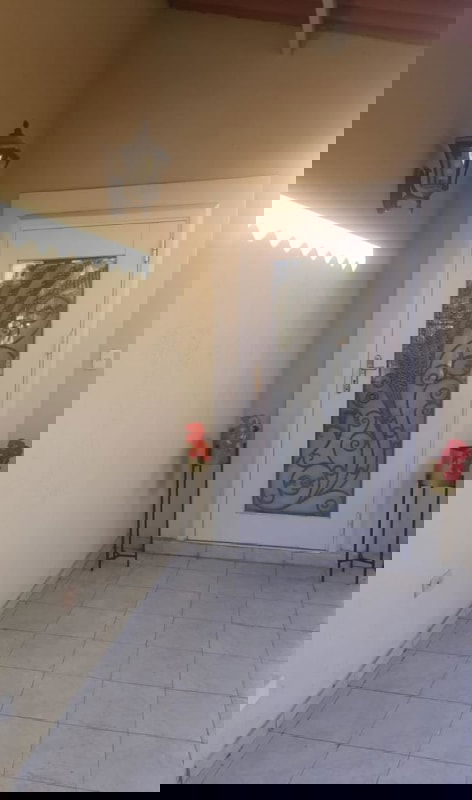 Entrance of home with decorative glass door and potted plants at Altos de Las Praderas