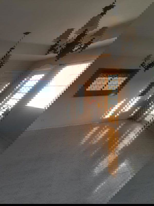 Bright living room with chandeliers and large windows in house Altos de Las Praderas Panama