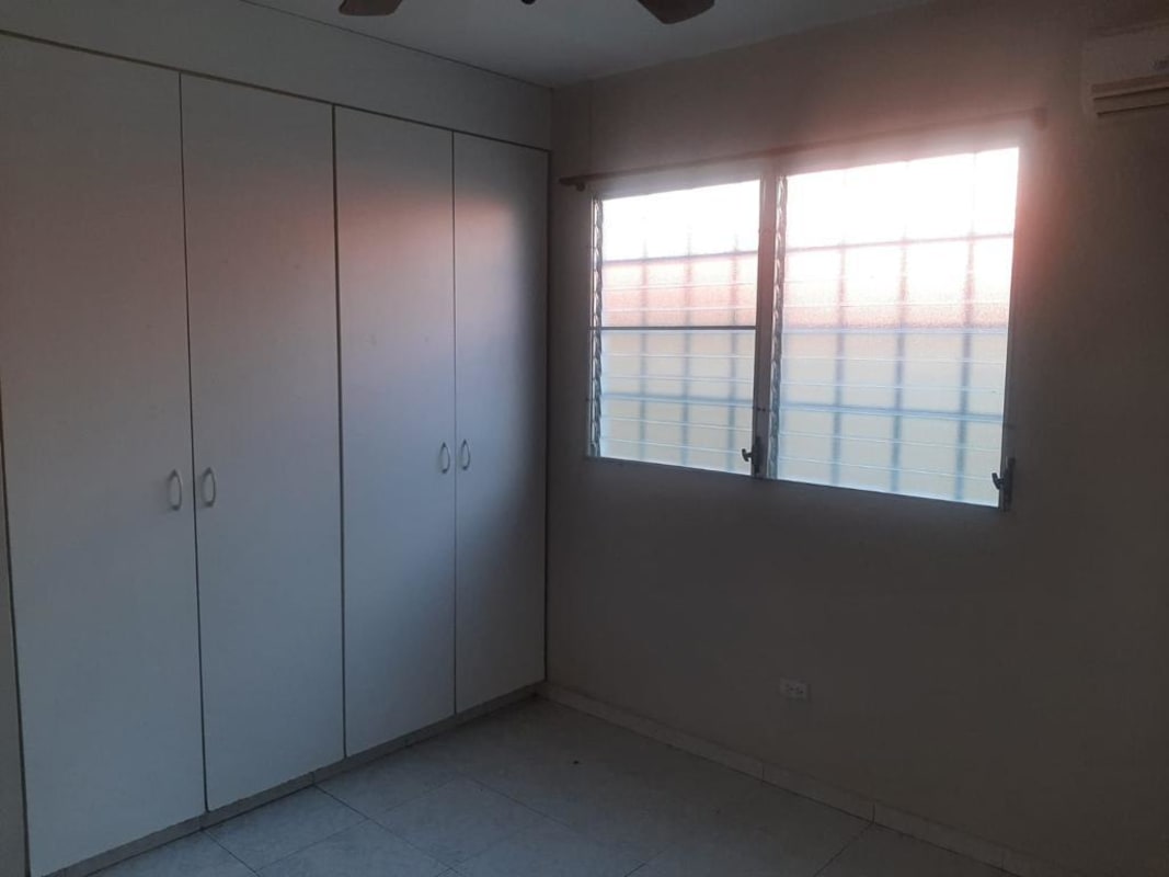 Bedroom featuring built-in wardrobes, AC unit, and ceiling fan in Altos de Las Praderas Panama