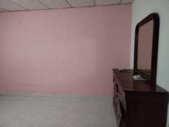 Bathroom with walk-in shower tiled walls in affordable house for sale Arraiján Panama