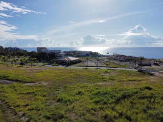 Vacant beachfront lot and developed Casamar condo resort on Pacific Coast Panama aerial view