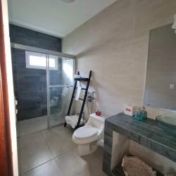 Master bedroom suite with garden views, large windows, AC and ceiling fan at Vista Mar Panama beach home