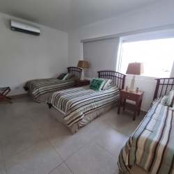 Contemporary kitchen with wood cabinets, granite counters, large window in Panama beach golf property