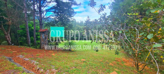 Grass field and rustic small tiled structure in tranquil natural setting Altos del María Panama