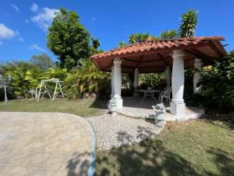 Outdoor Med-style gazebo in lush green backyard at Coronado Beach home Panama