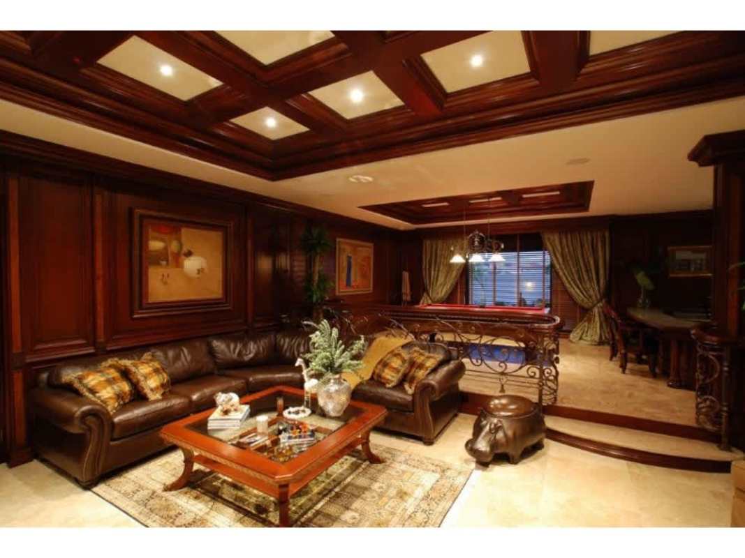 Large luxury living room with wood paneling, pool table, leather sofa in Camelias Costa del Este