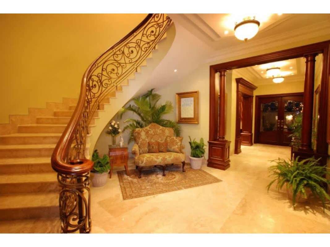 Luxury dining room with wooden wall details, large dining table, artwork Camelias Costa del Este rental