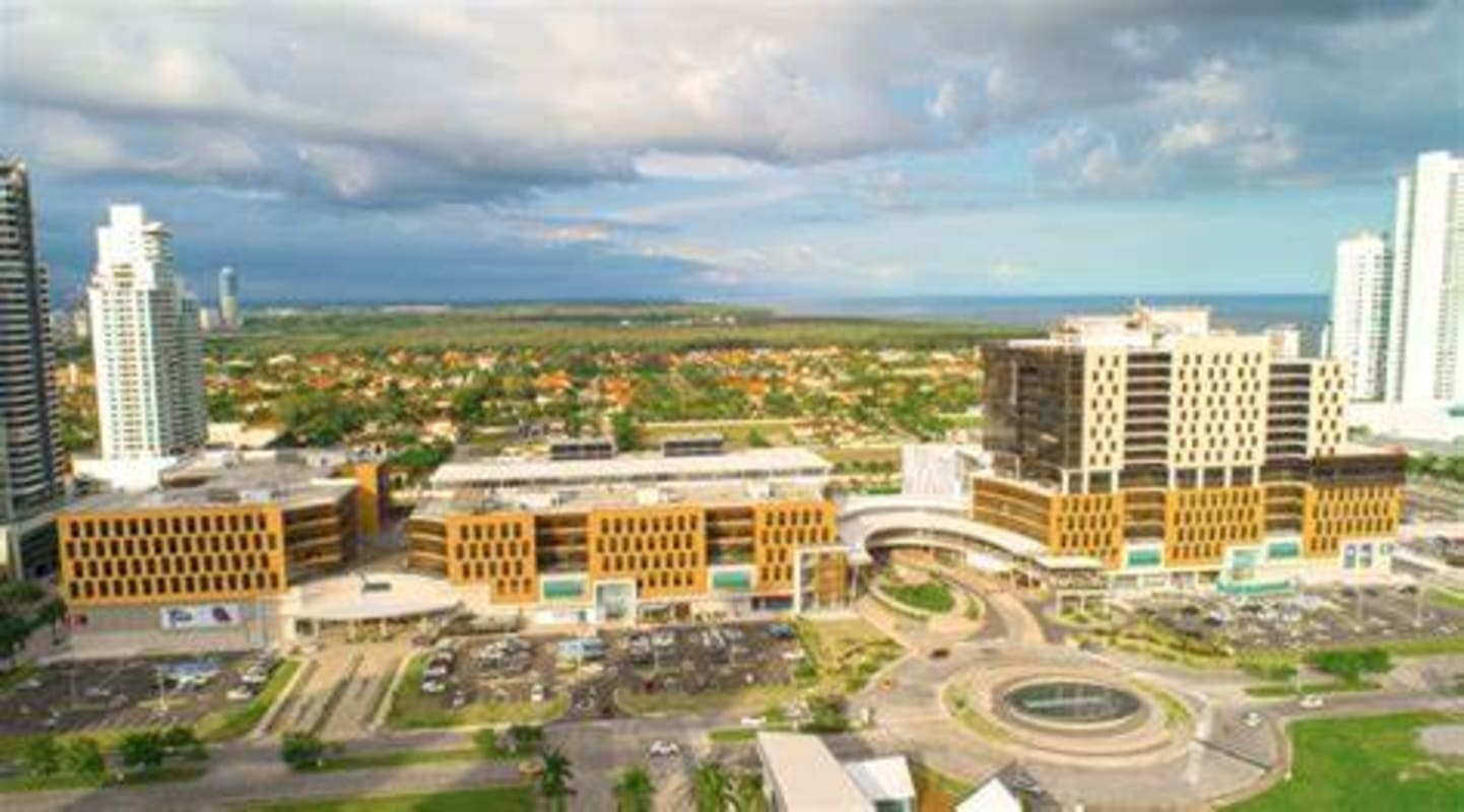 Aerial view of Town Center Costa del Este business complex with mall, parking, and office towers in Panama City