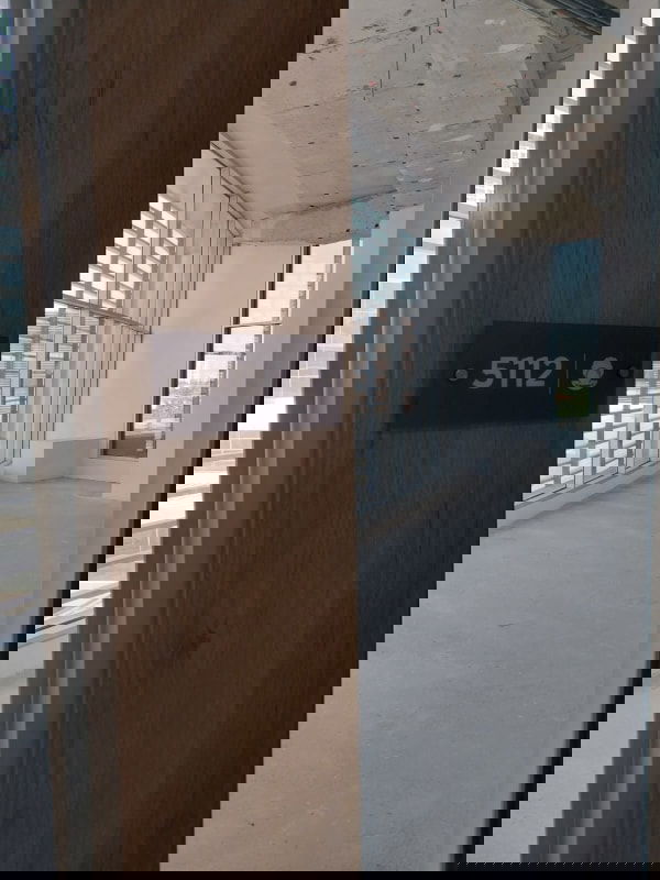 Unfinished office suite with glass door and concrete floor labeled Town Center Costa del Este Panama