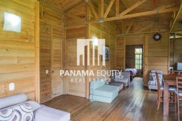 Large covered wood veranda ideal for relaxing surrounded by gardens in mountain cabin El Valle Panama