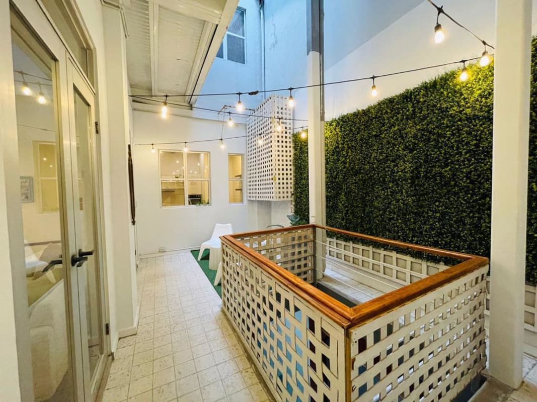 Bedroom with wooden wardrobe, large windows, French doors overlooking courtyard in PH Casco Viejo