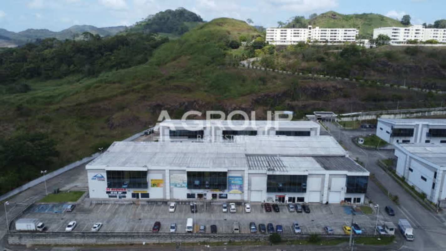 Front view of Ofibodegas Parque Centenario warehouse complex with parking and glass windows in Panama City