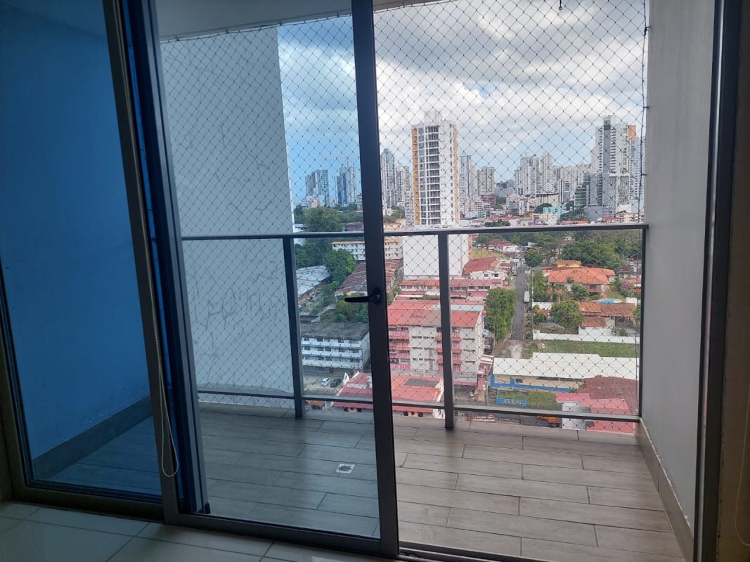 Living room with balcony sliding door and city views in PH Torre de Castilla Panama