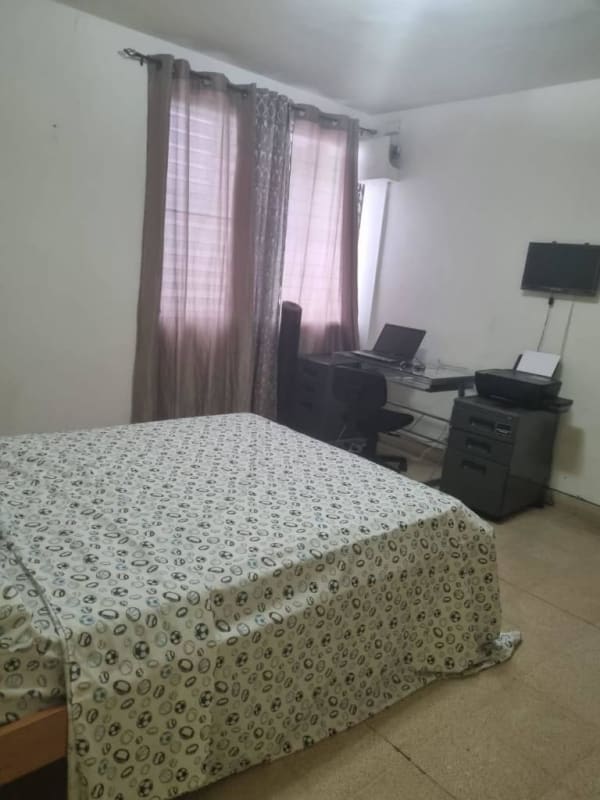 Large bedroom with workspace and TV in Via Argentina apartment Panama