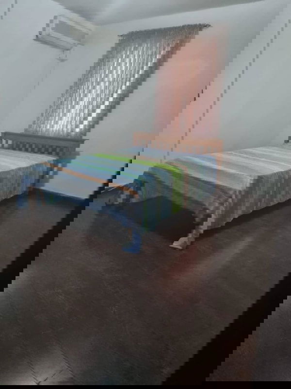 Bedroom with AC, wooden bed and striped linen PH Altos del Chase Panama