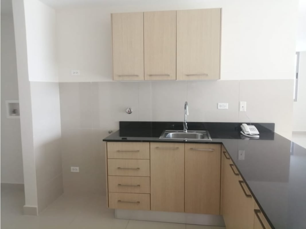 Modern kitchen with L-shaped granite countertop built-in cabinetry PH Torres de Castilla