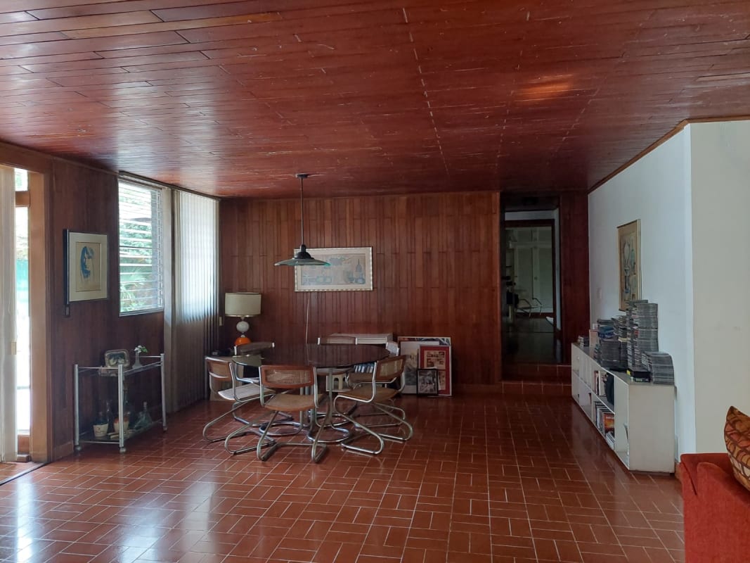 Bright living dining area with garden views, large windows and wood ceiling in luxury house Altos del Golf Panama