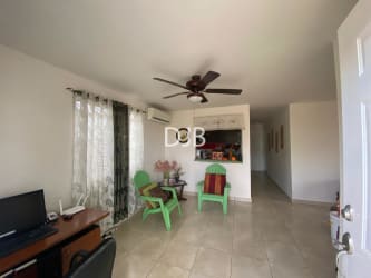 Bright living room with tiled floor, ceiling fan, AC, dining space at PH Las Olas Playa Dorada Panama