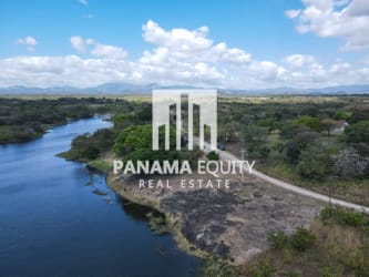 Lakefront lot with dirt road access scenic greenery mountain backdrop Panama