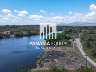 Aerial of Panama lakefront property with lush green surroundings and distant hills