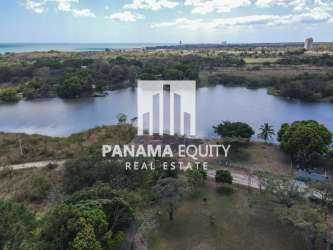 Aerial of waterfront Panama land with dirt road lake and coastline views