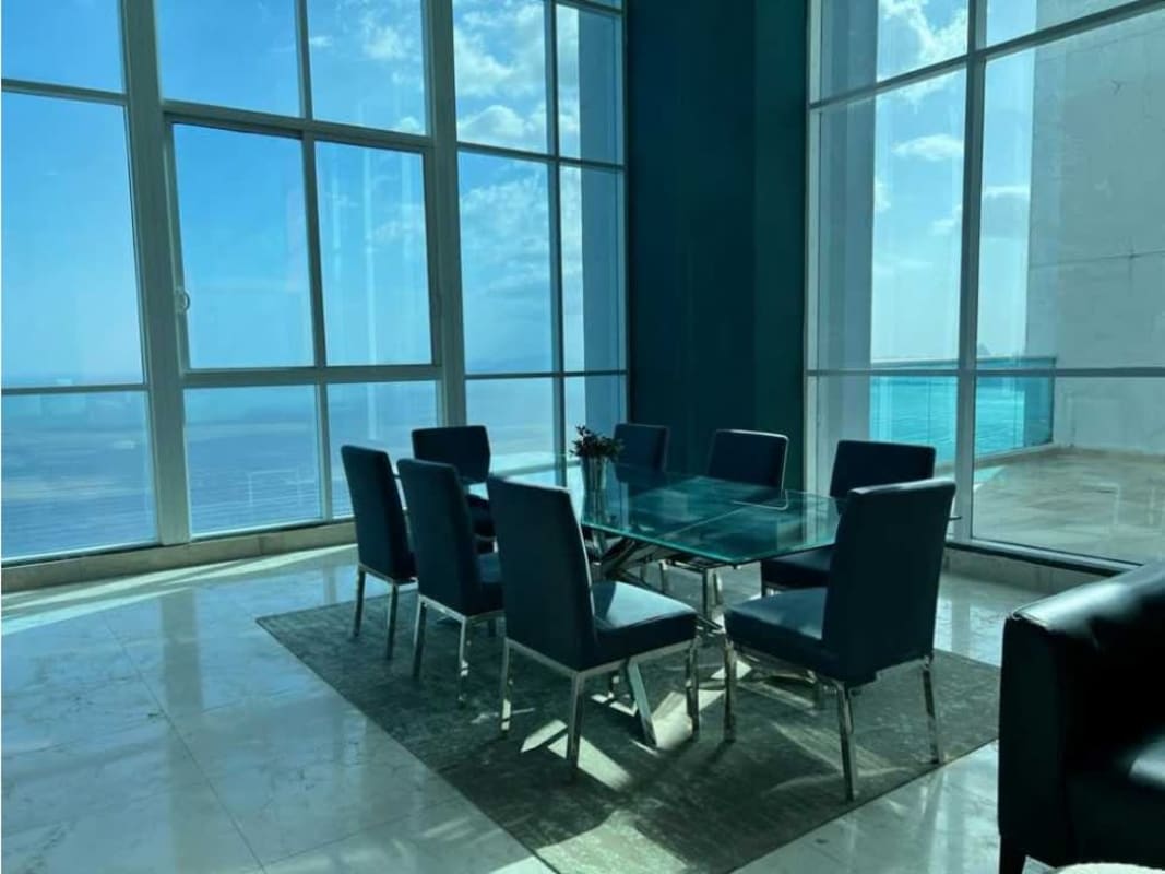 Luxury dining room with floor-to-ceiling windows facing Pacific ocean PH Vitri Costa del Este Panama City