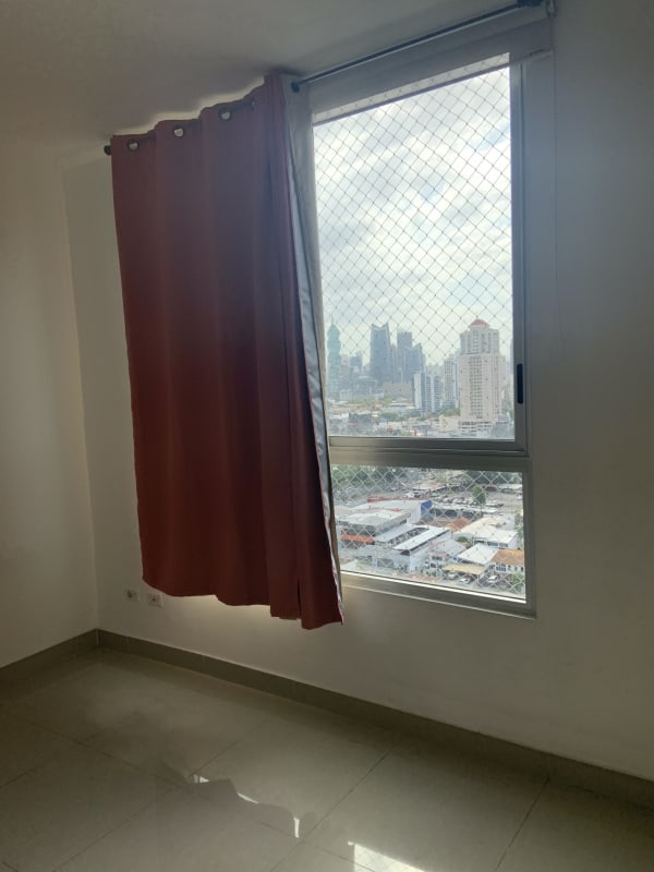Spacious bedroom with window and skyline views in PH Firenze Panama City
