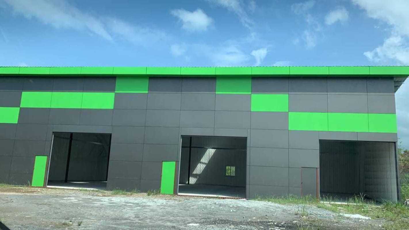 Modern industrial warehouse exterior facade with multiple loading bays at Altos del Chase Panama City