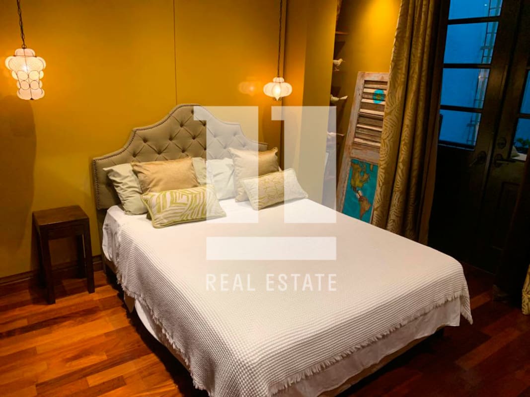 Cozy eclectic master bedroom with upholstered headboard and colonial decor Casco Viejo