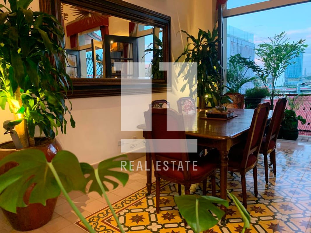 Dining area with large window city view, colonial tiles PH Casa Garay Casco Viejo Panama