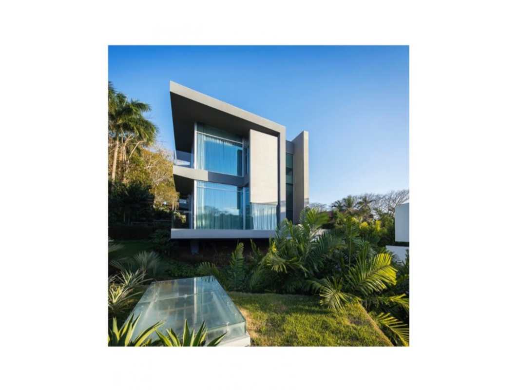 Modern multi-story luxury home with glass facade and tropical landscaping Clayton Panama