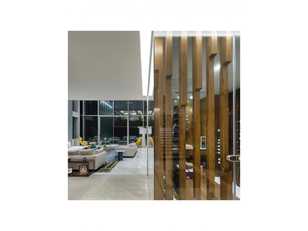 Bright living room with large glass walls overlooking tropical gardens Panama city luxury home