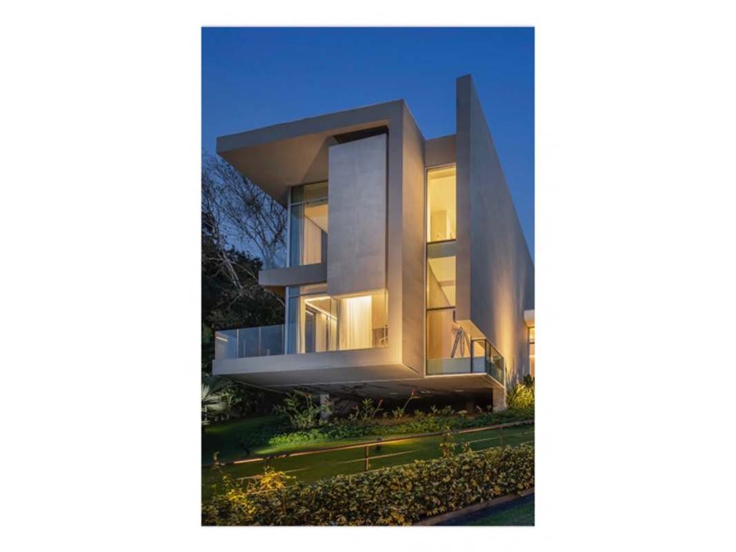 Contemporary interior featuring floating stairs, indoor pool and greenery Panama luxury home