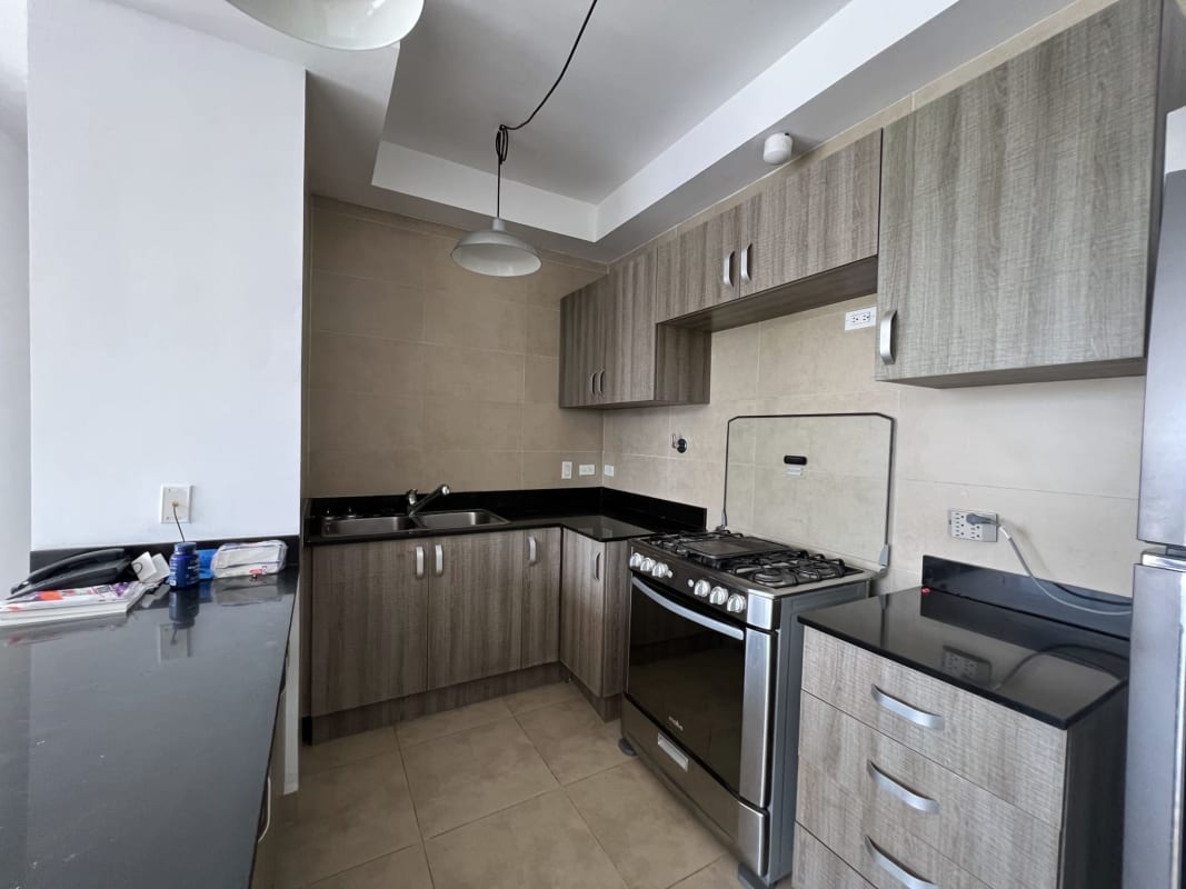 Fully equipped modern kitchen with granite countertops, stove and refrigerator PH The One Obarrio Panama City