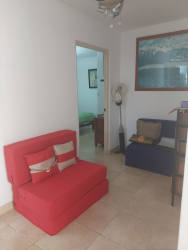 Well-lit bedroom with ceiling fan in beach apartment PH Farallón Panama
