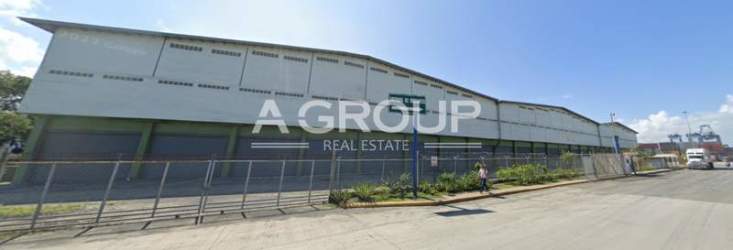 Exterior image showcasing truck docks and secured fence at Colon Free Zone warehouse