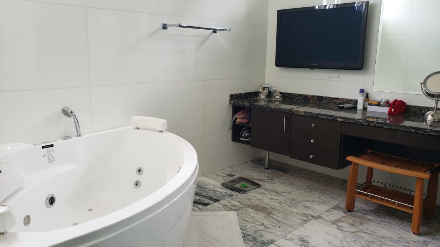 Luxury pool and jacuzzi surrounded by patio in Costa del Este house Panama