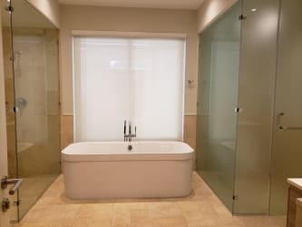 Large guest bedroom with two double beds and minimalist decor at Buenaventura Golf & Beach Panama villa rental