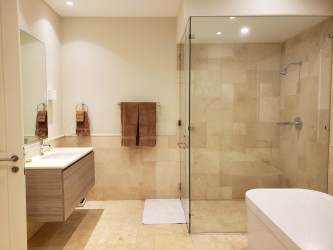 Bright open living space with huge windows, beige sofas, dining area, minimalist furniture luxury Buenaventura villa