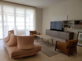Modern minimalist master bedroom with large bed and recessed lighting at Buenaventura Golf Resort