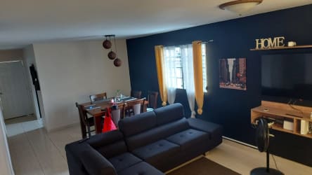 Spacious tile floor living and dining area with windows in Brisas del Sol house Panama