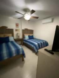 Fully equipped kitchen with stainless appliances and large windows facing ocean at Bijao Beach Condo